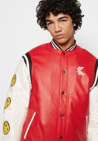 Karl Kani KARL KANI X SMILEY® COLLEGE JACKET - Casaco de pele sintética - red
