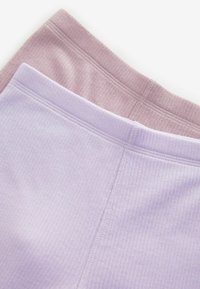 Dva para osnovnih rebrastih tajica u mekim nijansama lavande i prigušene mauve boje, s elastičnim pojasovima i glatkom teksturom tkanine.