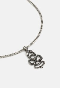 Silver-tone necklace featuring a textured snake-shaped pendant with intricate detailing, suspended on a smooth, twisted chain.