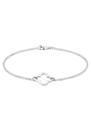 Bracelet chaîne en argent avec un pendentif central ouvert en forme de quadrilobe et une fermeture à mousqueton sur fond blanc.