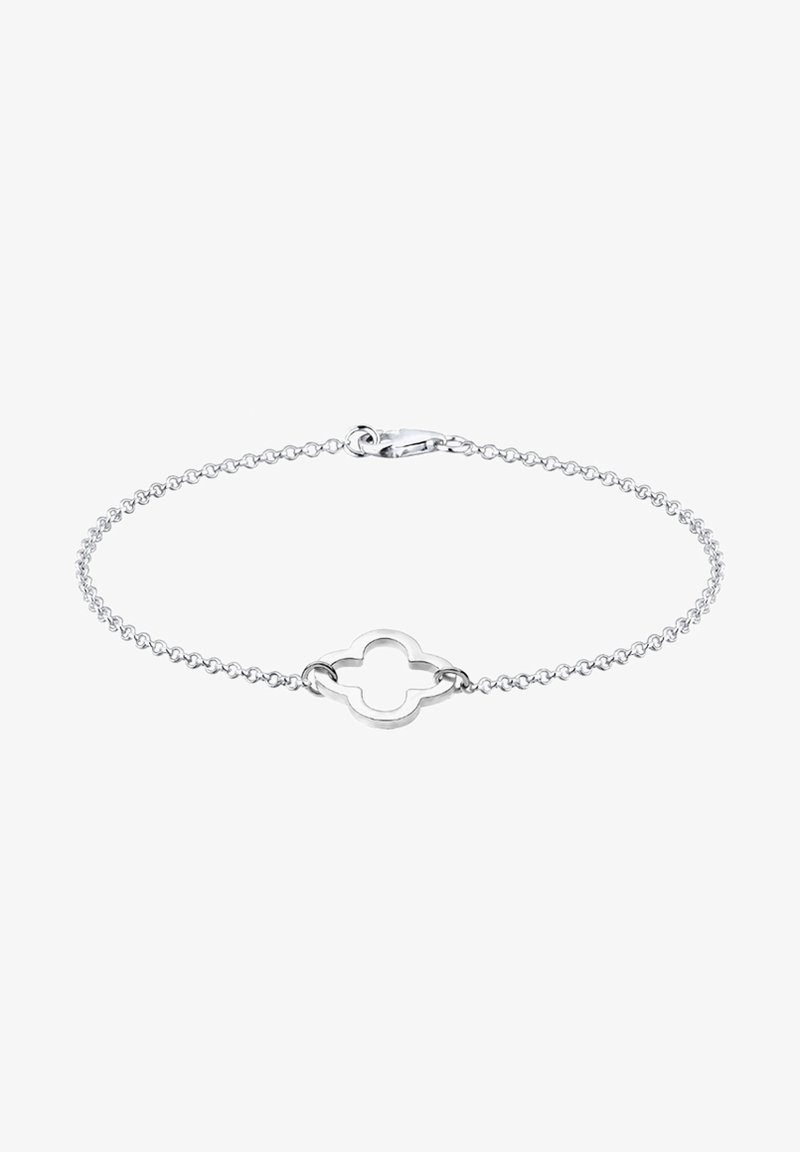 Bracelet chaîne en argent avec un pendentif central ouvert en forme de quadrilobe et une fermeture à mousqueton sur fond blanc.