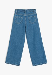 Lichtblauwe denim wijde pijpen jeans met een hoge taille, voorzien van twee achterzakken en zichtbare stiksels. Zachte textuur en een relaxte pasvorm.