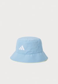 Lys blå bucket-hatt laget av stoff med bred brem, med en hvit Adidas-logo og en neongul aksent langs bremkanten.