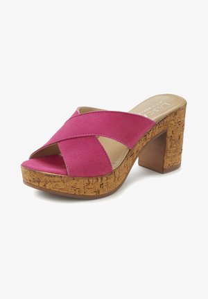 Pink suede slide sandal with crossed straps, cork platform, and block heel. Smooth interior and textured outsole for grip.