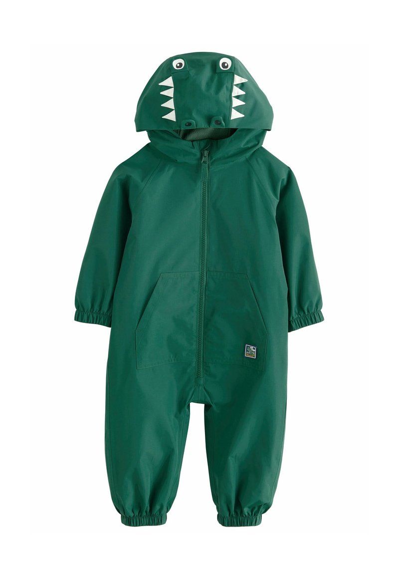 Salopette de pluie verte avec capuche sur le thème des dinosaures, présentant des dents et des yeux blancs. Comprend des poignets élastiques et deux poches frontales. Matériau imperméable.