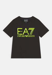 Black cotton t-shirt featuring a prominent reflective EA7 logo in neon yellow and a crew neckline, short sleeves, and a standard fit.