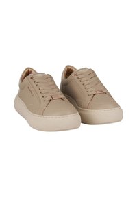 Sneakers in pelle beige con lacci piatti, linguetta imbottita, suola texturizzata e accenti di branding discreti sul lato e sulla linguetta.