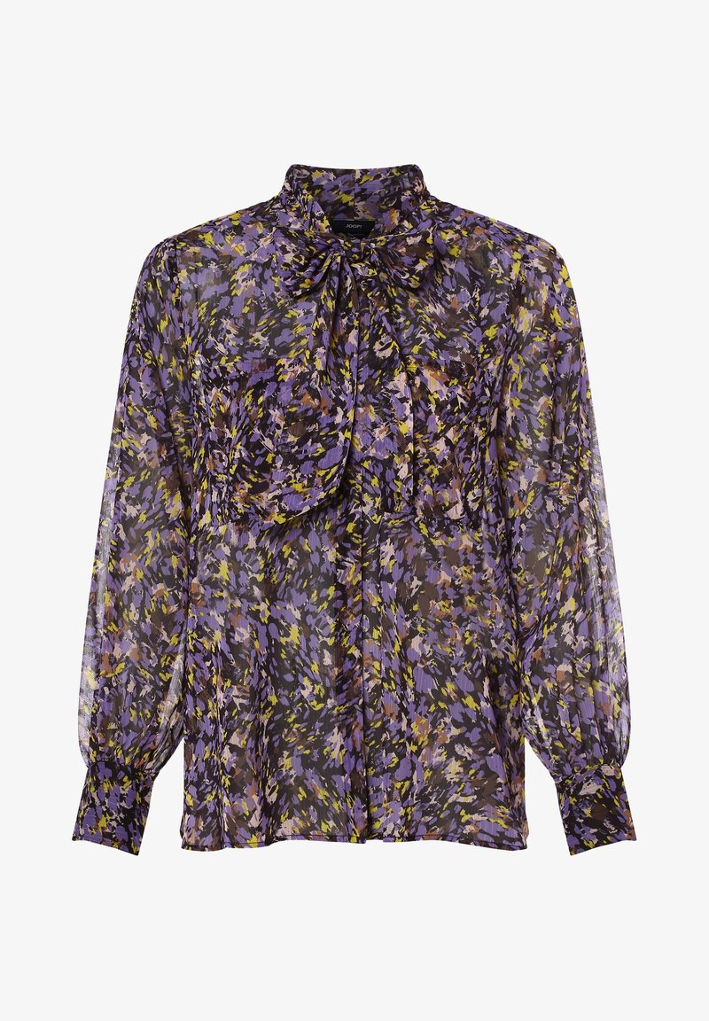 Blouse longue transparente à manches longues avec motif floral abstrait violet, jaune et noir et grand col noué en nœud papillon.