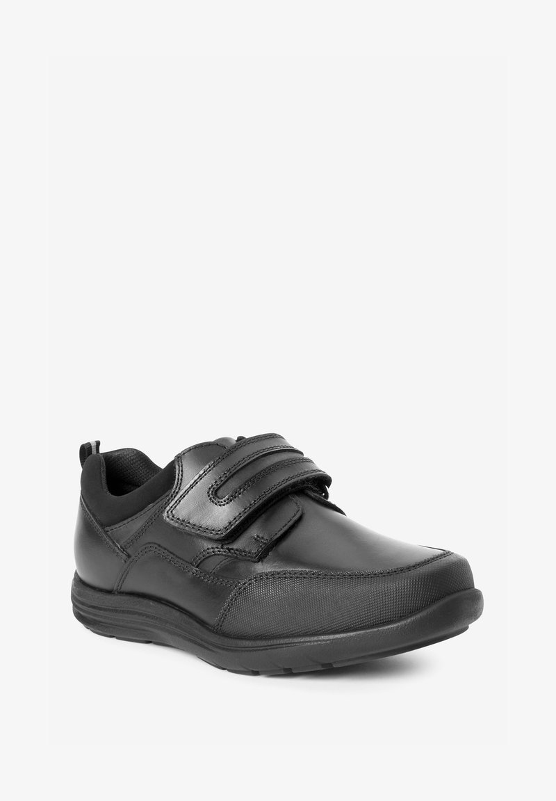Pantofi sport negri cu un superior din piele netedă, două curele velcro și o talpă din cauciuc texturat pentru aderență și confort.