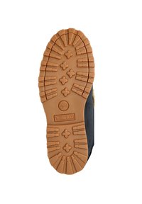 Rubber outsole with a multi-directional tread pattern; brown color with Timberland logo in the center. Black fabric upper.