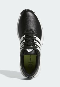 Czarne buty sportowe z syntetycznej skóry, z białymi paskami, czarnymi sznurówkami i zielonym akcentem wewnątrz. Okrągły czubek i amortyzowana podeszwa.