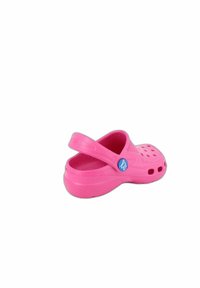 Pink rubber clog with ventilation holes, back strap, and smooth texture. Features a round blue logo on the side.