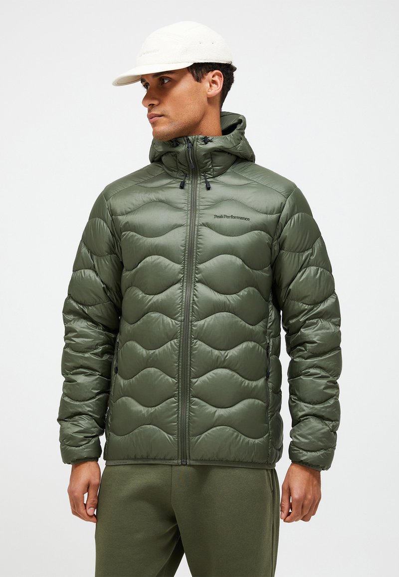 Green puffy jacket with a hood, featuring a quilted design and a full front zipper. Made from a shiny material with a smooth texture.