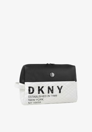 Bolso tipo pouch DKNY en blanco y negro, con una sección inferior acolchada en blanco y una superior lisa en negro, logo en la parte frontal y cierre con cremallera en la parte superior.