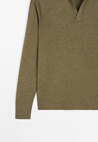 Olivgrüner V-Ausschnitt-Pullover aus weichem Stoff, mit langen Ärmeln und gerippten Bündchen und Saum. Leichte Textur mit dezentem Muster.