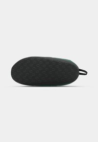 Shoe sole with a black rubber bottom featuring a textured pattern and green upper material. Includes a loop for easy wearing.