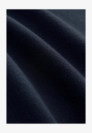 Navy blue fabric with a soft, textured surface, displaying subtle wrinkles and ripple patterns, indicating a stretchable material.