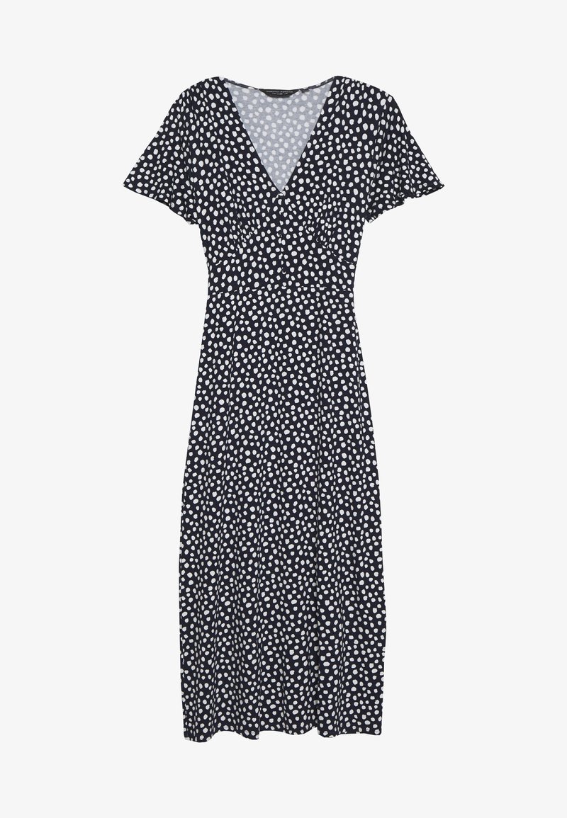 Robe navy à pois blancs, décolleté en V, manches flottantes et taille cintrée qui se prolonge en une jupe mi-longue en A.