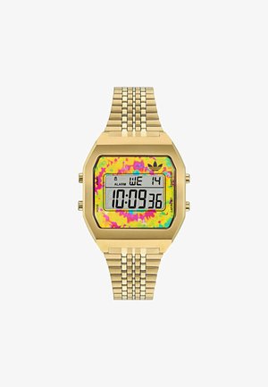 Skaitmeninis laikrodis su auksiniu metaliniu diržu ir aštuonkampiu korpusu. Spalvingas tiesiai dažytas ciferblatas rodo laiką ir datą. Yra juodi mygtukai.