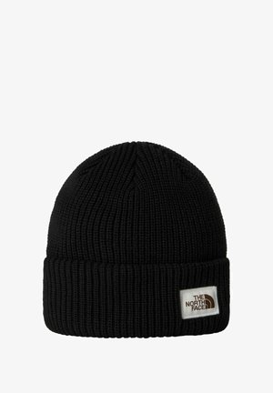 Sort strikket hue med ribbet tekstur, med en foldet kant og et hvidt mærke med The North Face-logoet på forsiden.