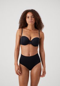 Black padded bra with adjustable straps; high-waisted black underwear. Smooth fabric with slight sheen; minimalist design, no visible patterns.