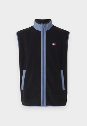 Gilet en polaire noir avec un col montant, présentant des accents bleu clair et des poches, fermeture zippée à l'avant et un petit logo sur la poitrine.
