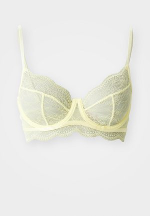 Soutien-gorge en dentelle jaune clair avec armatures, bords festonnés délicats et bretelles réglables. Tissu transparent avec un motif floral.