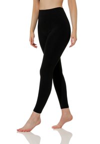 Leggings noirs taille haute avec une texture lisse et élégante et un design ajusté, se rétrécissant au niveau de la cheville, offrant une couverture intégrale.