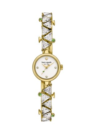 Goldene Kate Spade Armbanduhr mit weißem Zifferblatt, Kristall-Stundenmarkierungen, goldfarbenen Zeigern und einem Band, das mit großen klaren und kleinen grünen Edelsteinen geschmückt ist.