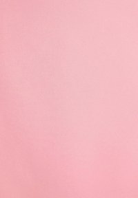 Tessuto rosa chiaro con una texture liscia e opaca. La superficie è uniforme, senza motivi o cuciture visibili. Adatto per abbigliamento o rivestimenti.