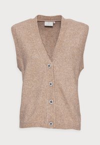 Veste sans manches en maille beige avec un col en V, cinq boutons décoratifs en forme de fleur noir et blanc, et une finition douce et texturée.