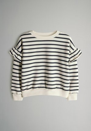 Ilgas rankovėmis megztinis su baltomis ir juodomis horizontaliosiomis juostomis, raukiniais ant viršutinių rankų dalių ir ribotomis apačia bei rankogaliais.