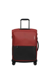 Two-tone red and black soft suitcase with four wheels, extendable handle, side grip handle, front zipper pocket, and Samsonite logo on front.