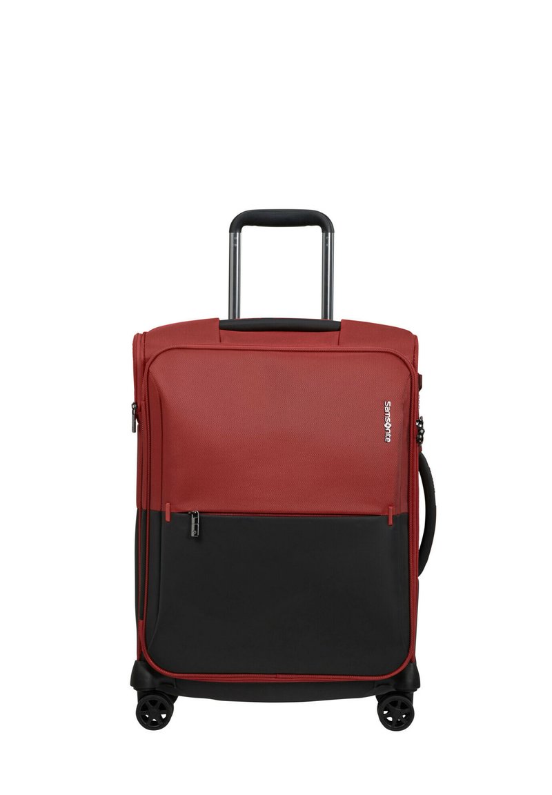 Two-tone red and black soft suitcase with four wheels, extendable handle, side grip handle, front zipper pocket, and Samsonite logo on front.