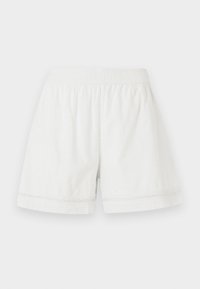 White linen shorts featuring an elastic waistband, relaxed fit, and decorative lace trim at the hem. Smooth texture and casual design.