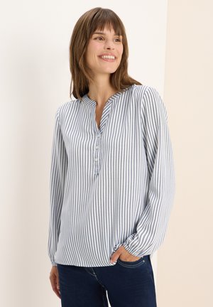 Striped blouse in light blue and white, featuring a henley neckline, long sleeves with elastic cuffs, and button detailing at the neckline.