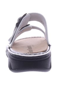 Zwarte plateau sandaal met witte leren banden, ronde neus, gemodelleerde voetbed en decoratieve stiksels langs de rand van de zool.