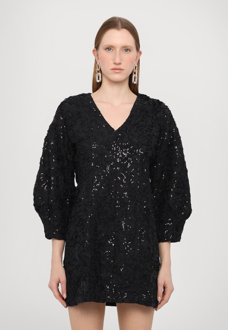 Black dress featuring a textured floral pattern, V-neckline, and puff sleeves. Includes sequins for added shimmer and a fitted silhouette.