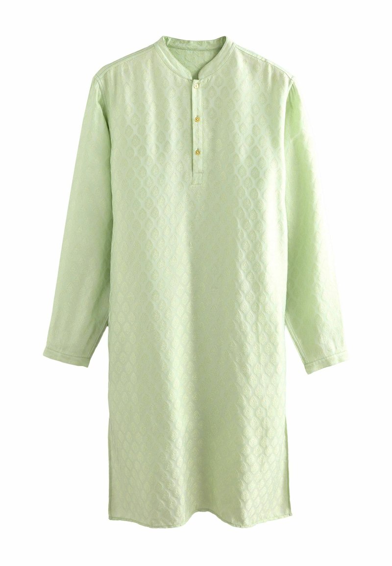 Tunique verte clair à manches longues en tissu texturé avec un motif en losanges, dotée d'un col rond et d'une patte de boutonnage à trois boutons.