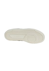 White rubber sneaker sole with a textured tread pattern, featuring KSWS brand logo and unique grooves for traction.