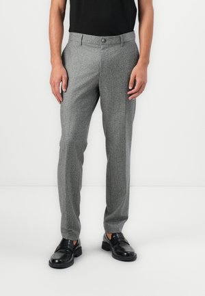 Gray textured trousers with a tailored fit, featuring a button closure and pockets, paired with black leather loafers.