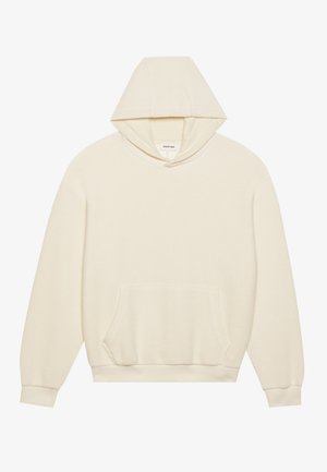 Hoodie couleur crème avec un motif tissé texturé. Dispose d'une poche kangourou à l'avant et d'une capuche ajustable avec des poignets et un ourlet côtelés.