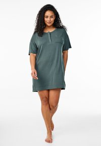 Tumši zaļš īsroku nakts tērps, izgatavots no mīksta, gluda auduma. Iespējas piekariņš ar pogu un krūšu kabata detaļu pievienošanai.