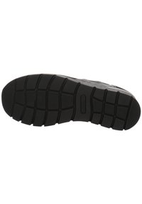Sole di sneaker nera con una superficie in gomma texture, caratterizzata da motivi in rilievo per la trazione e un design a punta arrotondata.