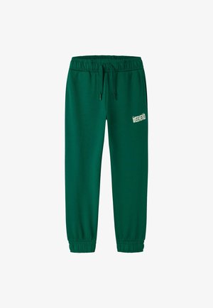 Pantalon de survêtement vert foncé avec taille et chevilles élastiques, cordon de serrage et texte blanc "Weekend" sur la partie supérieure de la cuisse gauche.