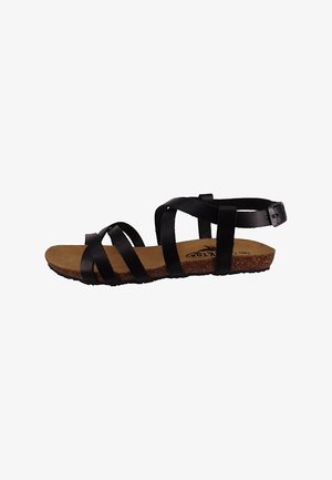Black strappy sandal with a cork footbed, featuring thin, overlapping straps and an adjustable ankle strap. Textured rubber sole.