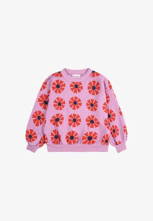 Pink sweatshirt featuring a repeating pattern of red flowers with black centers. Designed with a round neckline and puffed sleeves.