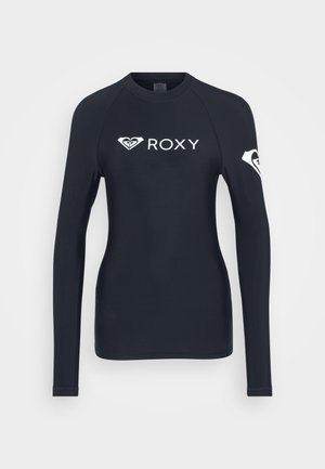 Navy long-sleeve rash guard featuring a white Roxy logo on the chest and sleeve, made from a lightweight, stretchy fabric.