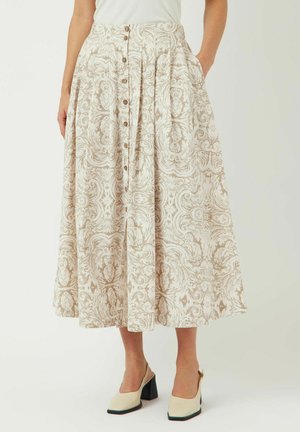 Maxi-skirt laget av en lys beige stoff, med et svirrende mønster, frontlukking med knapper og sidelommer. Skreddersydd med folder og en flytende design.