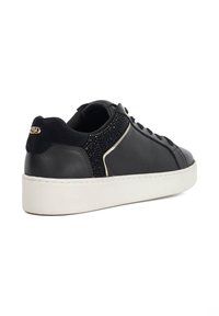 Black leather sneaker with suede accents, white rubber sole, and decorative black beading on the heel, featuring gold logo detail.